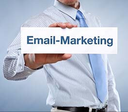a guy with a shirt and tie holding up a sign that says 'Email Marketing'