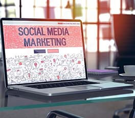 a laptop with 'Social Media Marketing' on the screen