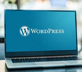 laptop with the word 'WordPress' on the screen